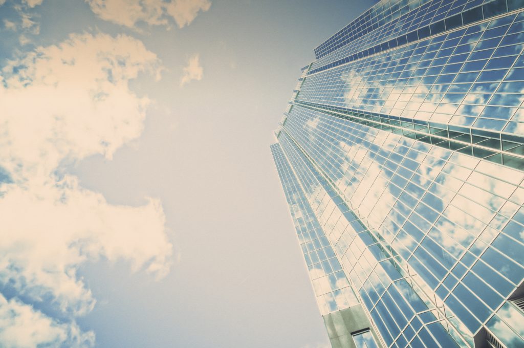 Looking up at the sky with a tall building in the shot