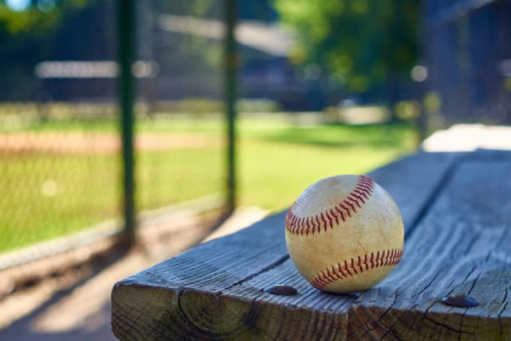 Baseball on picnic table.